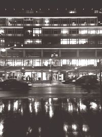 Reflection of illuminated buildings in city at night