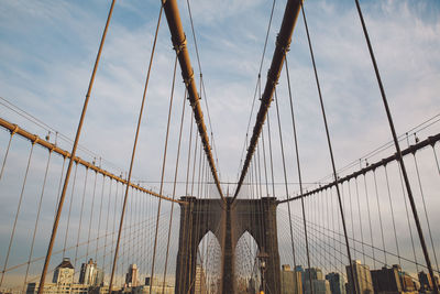 Brooklyn bridge against cloudy sky