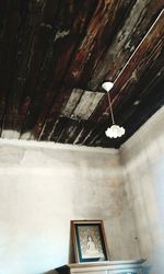 Low angle view of electric lamp on building