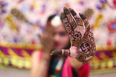 Close-up of bride showing henna tattoo