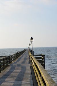 Pier over sea against clear sky