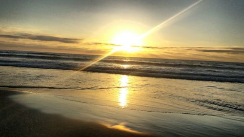 Scenic view of beach against sky during sunset