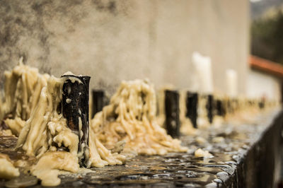 Candles arranged in row on table