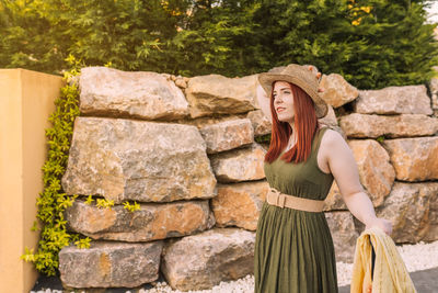 Portrait of woman standing against trees