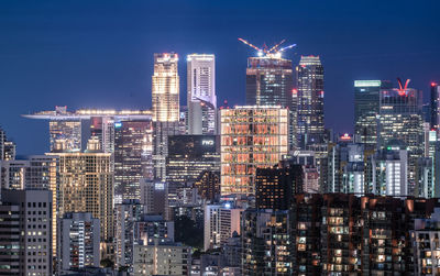 Illuminated cityscape against sky at night