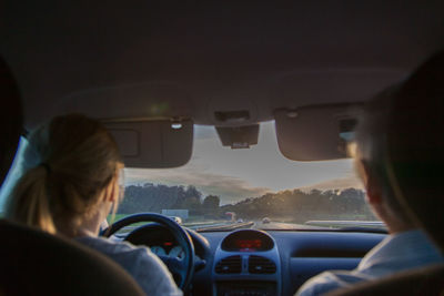 Rear view of man and woman in car