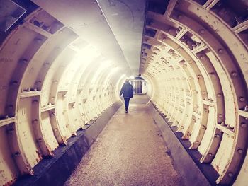 Rear view of woman walking in corridor