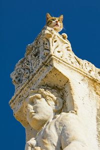 Low angle view of statue against clear blue sky