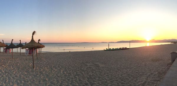 Scenic view of beach against sky during sunset