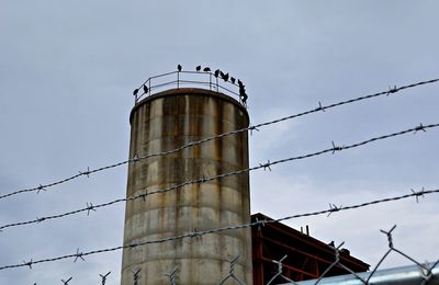 Low angle view of factory against sky