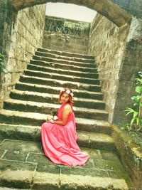 Portrait of young woman on steps