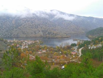 Scenic view of lake and mountains against sky