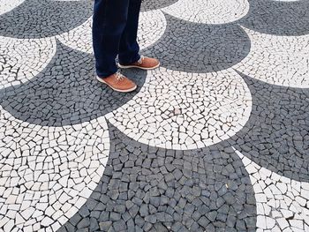 Low section of man standing on footpath