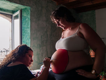 Side view of mother and woman