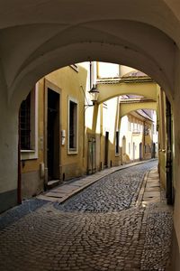 Empty alley amidst buildings in city