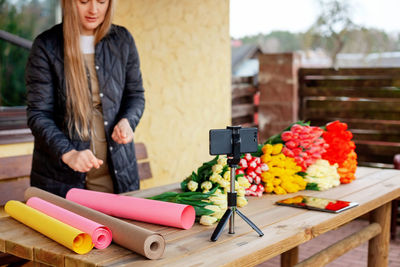 Close-up of the phone on which a woman is shooting a video for her blog, a florist girl 