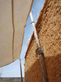 Low angle view of fabric tied to old house