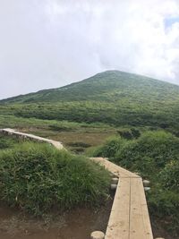 Scenic view of mountains against cloudy sky