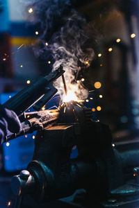 Close-up of man repairing machinery