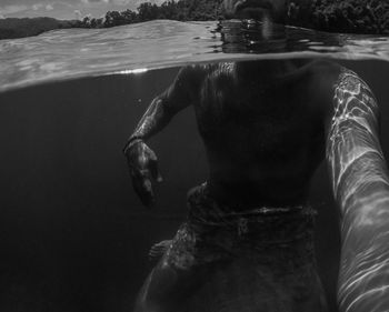 Low section of woman swimming in sea