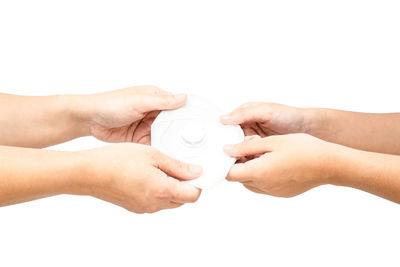 Midsection of woman holding hands over white background