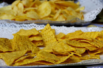 High angle view of tortilla and potato chips served in plate