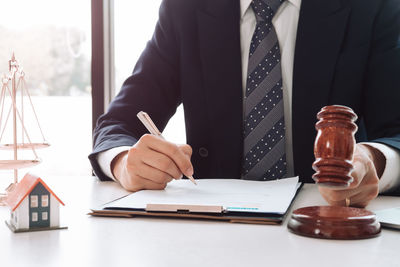 Midsection of man working on table