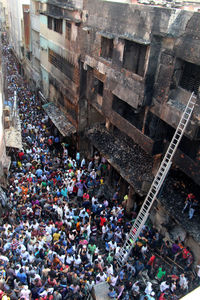 High angle view of crowd amidst buildings in city