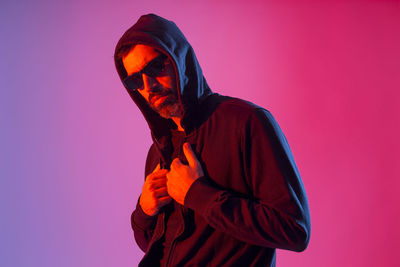 Man standing against red background