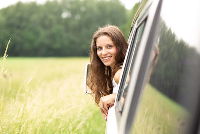 Portrait of smiling young woman in field