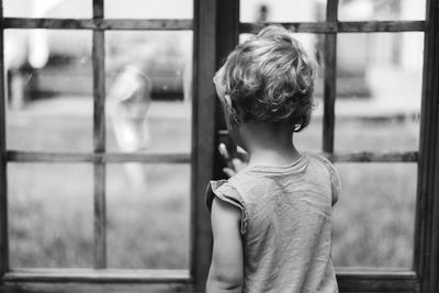 Portrait of baby girl playing in wooden house