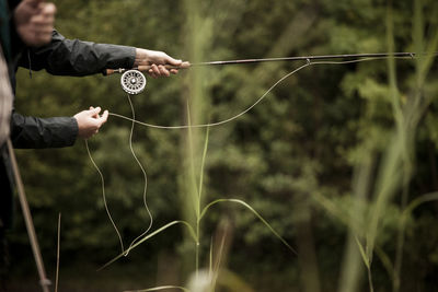 Midsection of person fly fishing in ireland 