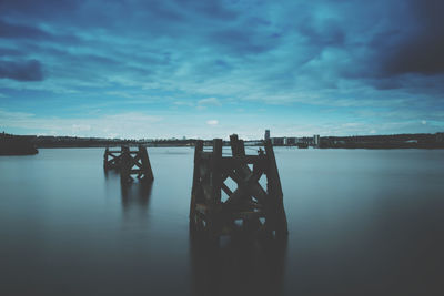 Pier over lake against sky