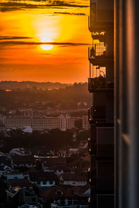 High angle view of illuminated buildings against sky during sunset
