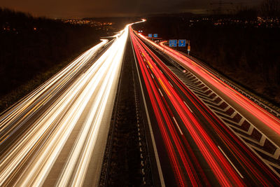 Light trails on road in city at night