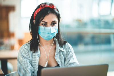 Portrait of woman using laptop