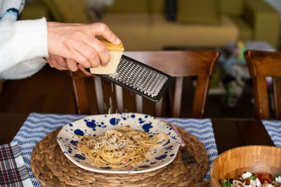 Midsection of man preparing food in restaurant