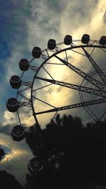 Low angle view of silhouette ferris wheel against sky