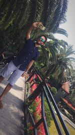 Man photographing by tree