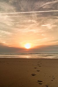 Scenic view of beach against sky during sunset