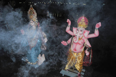 Ganesha statue on beach at night