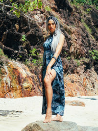 Young trans woman standing on rock