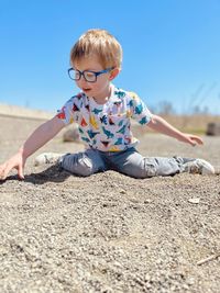 Full length of boy playing with sand