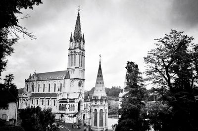 Low angle view of church against cloudy sky