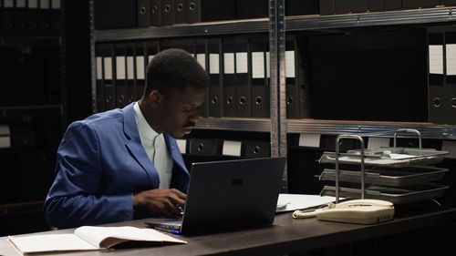 Young man using laptop at office