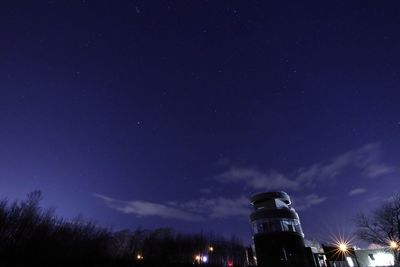 Low angle view of illuminated building against sky at night