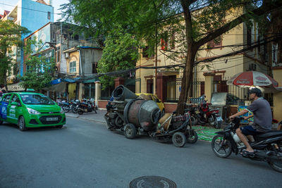 Bicycles on street by buildings in city