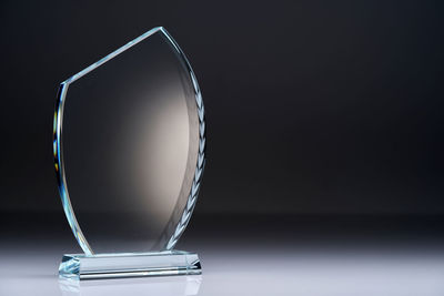 Close up of crystal trophy against gray background