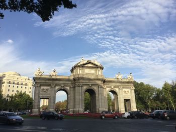 Cars in city against sky