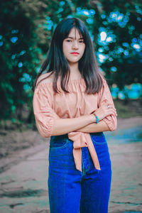 Portrait of a beautiful young woman standing outdoors